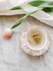 pink petaled flowers near teacup and saucer