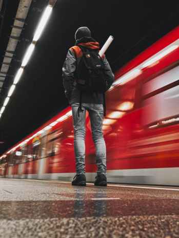 low angle photography of person standing on subway station